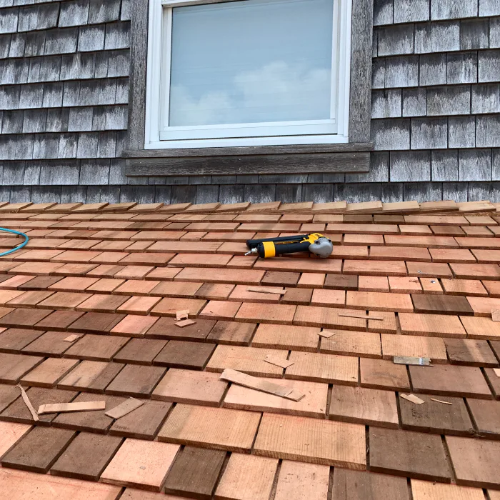 close up of a cedar roof work in progress with nail gun atco nj