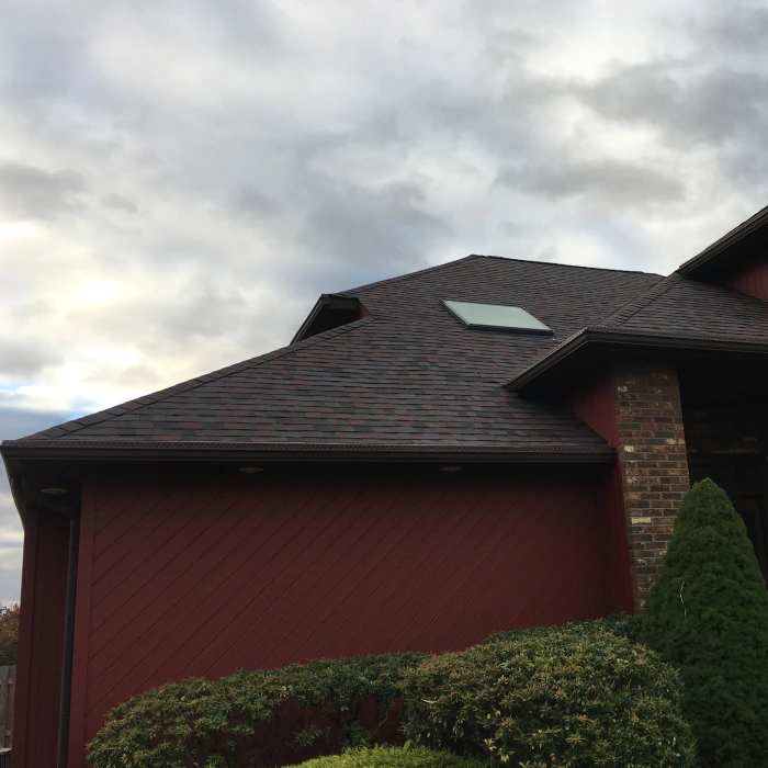 close up of a house red wall newly installed asphalt shingles atco nj